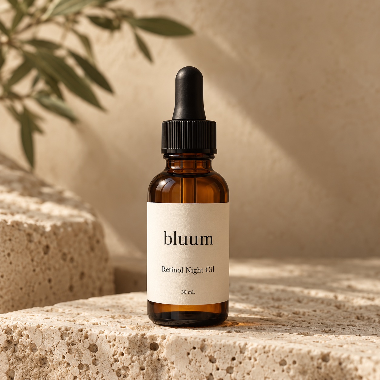 Bluum Retinol Night Oil in an amber dropper bottle on warm stone